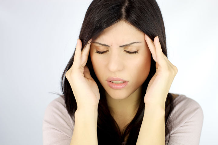 Woman experiencing sinus headaches