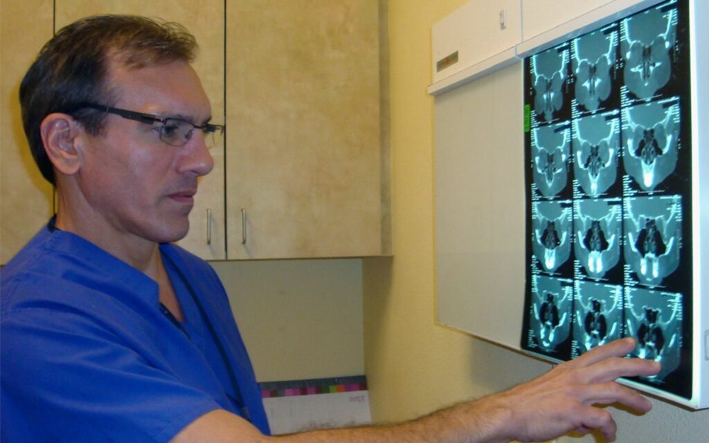 Dr. Nalbone looking at CT scans from one of his patients