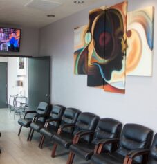 A waiting room with a tv at Vegas Breathe Free