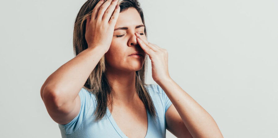 A woman with sinus and eye pain