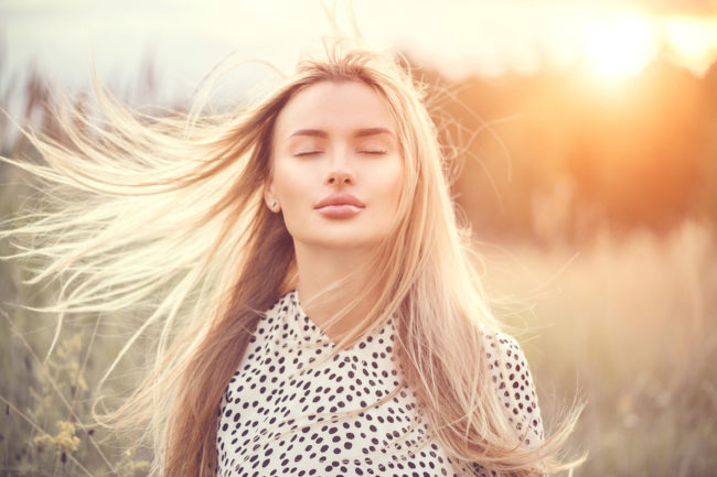 Close-Up Portrait of woman on a windy day experiencing sinus problems