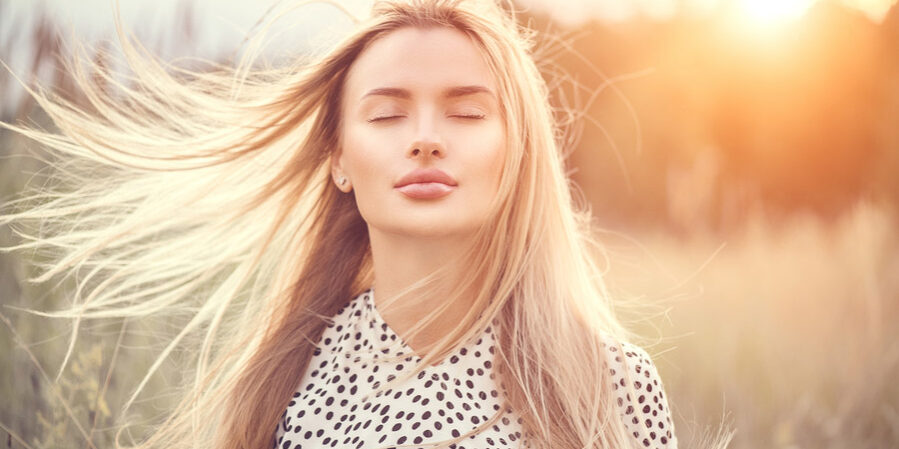 Close-Up Portrait of woman on a windy day experiencing sinus problems