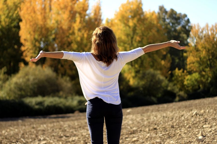 woman breathing better after visiting an ent specialist enjoying nature